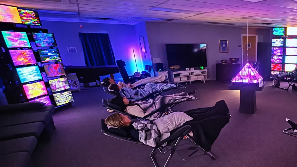 Members relaxing in zero-gravity chairs during a session in the Quantum Light Room